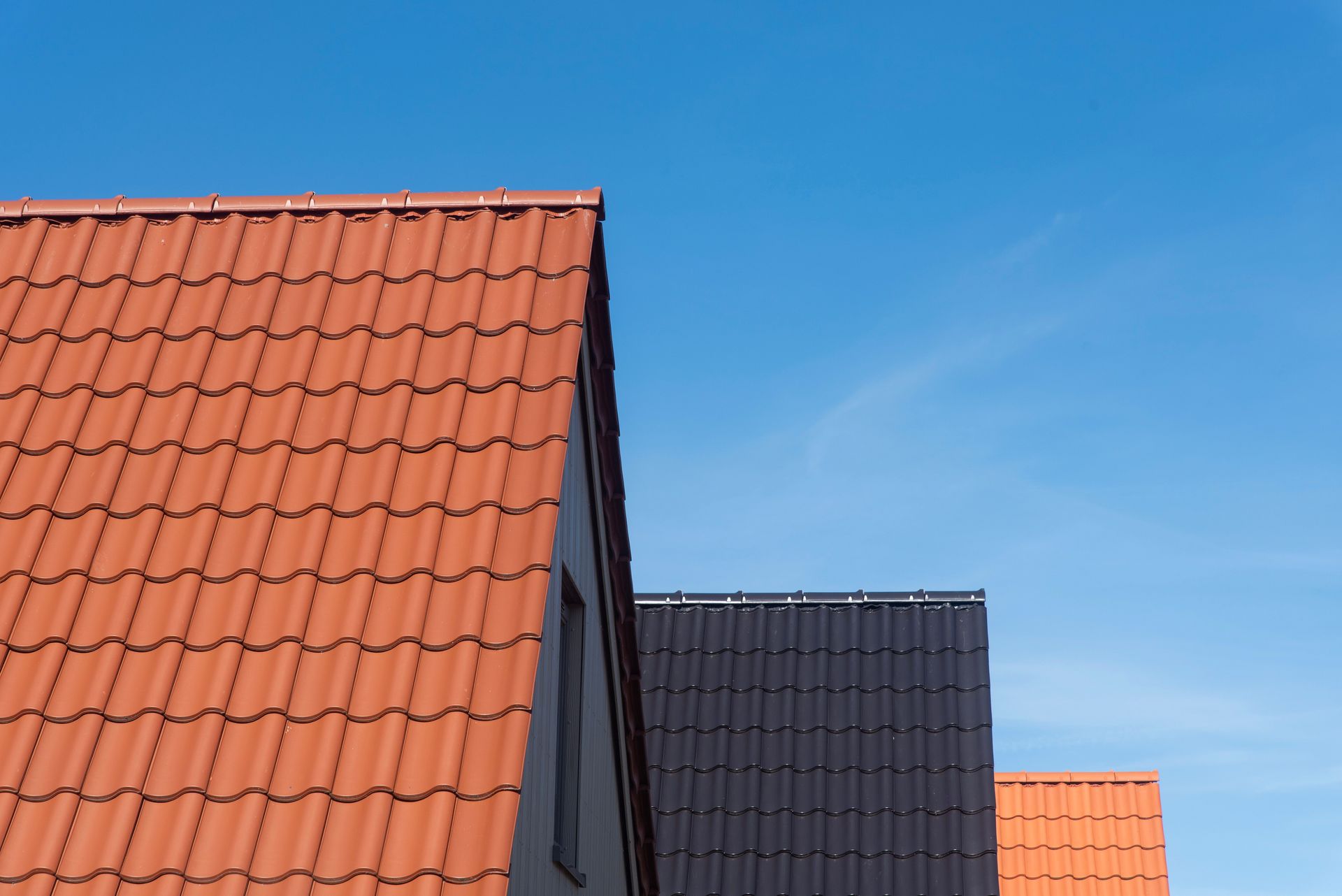 Vibrant rooftops contrasting with clear blue sky, showcasing architecture.